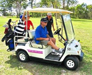 People riding a golf cart