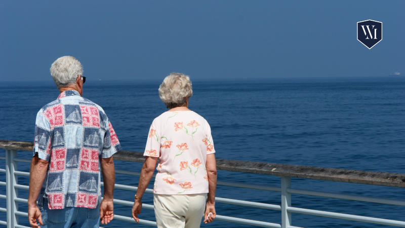 Elderly couple enjoying a cruise ship deck with ocean views.